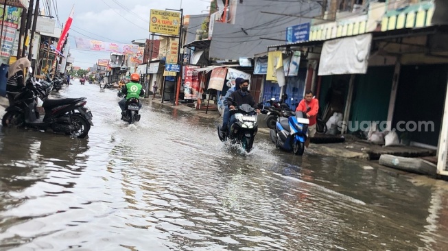 Hujan deras yang mengguyur sejak Selasa (28/1/2025) malam, membuat sejumlah titik di Kota Bekasi banjir. Salah satu wilayah yang terdampak banjir adalah Pondok Ungu Permai (PUP), Jalan Sektor V, Kecamatan Babelan, Bekasi. [Suara.com/Mae Harsa]